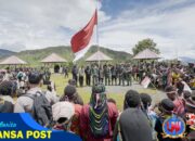 Bersama Masyarakat, Satgas Yonif 715/Motuliato dan Apkam Puncak Jaya Kibarkan Bendera Merah Putih Raksasa di momen tanggal 1 Mei 2025